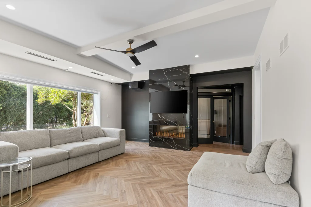 Modern living room with chevron-patterned wood floor