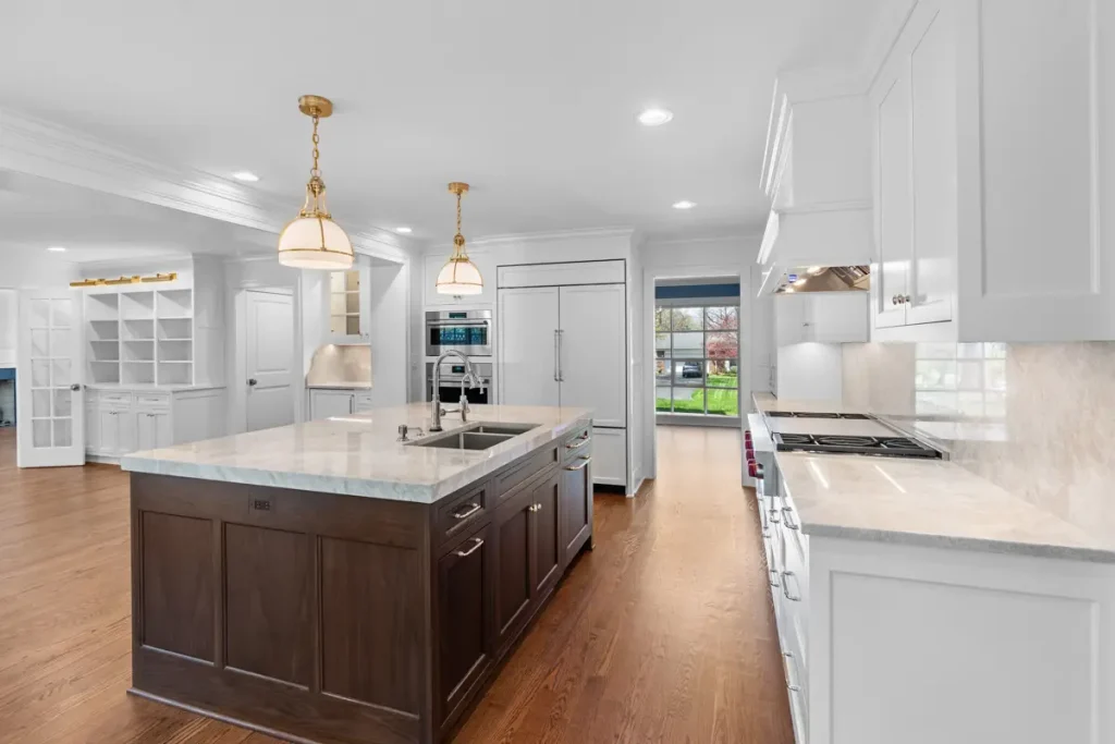 Spacious, modern kitchen with a central island featuring a dark wood base and light countertop