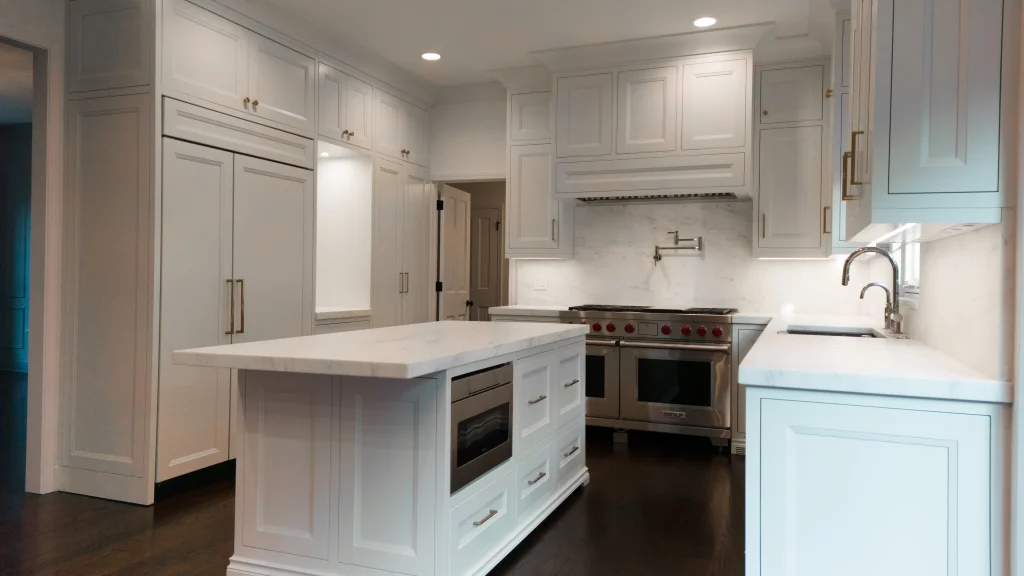 Spacious modern kitchen with white cabinetry, marble countertops, and a central island