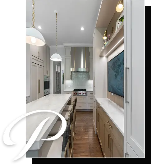 A modern kitchen features a long marble island with high chairs