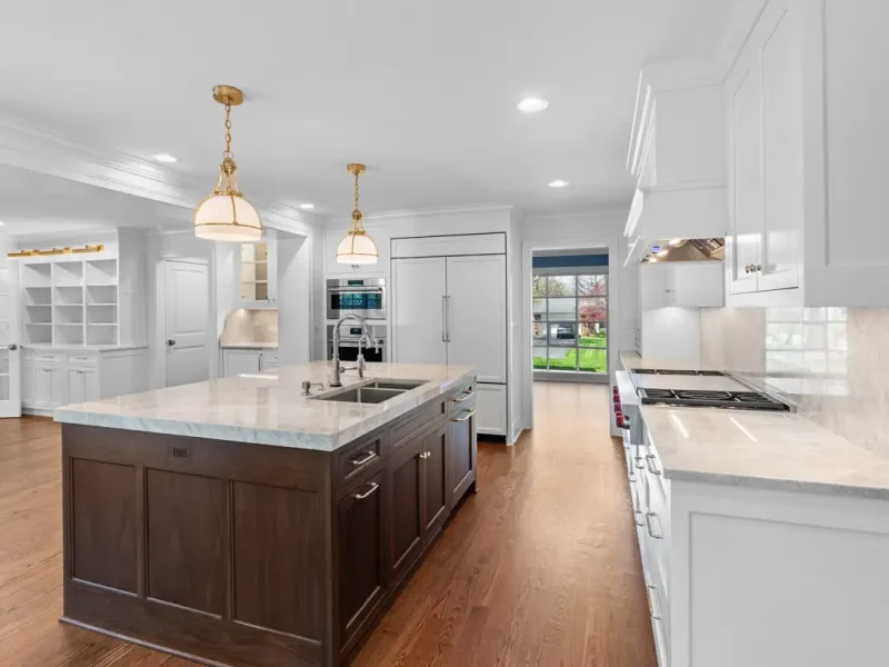 Spacious, modern kitchen with a central island featuring a dark wood base and light countertop